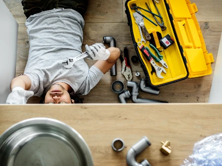 Someone fixing a kitchen sink