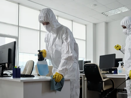 People sanitizing computers