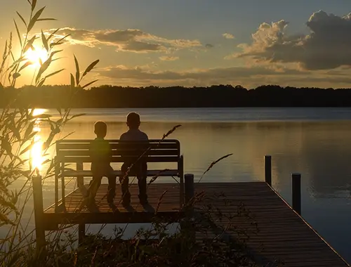 Two kids enjoying the views of the lake.