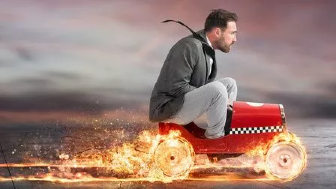 A guy speeding in a toy car