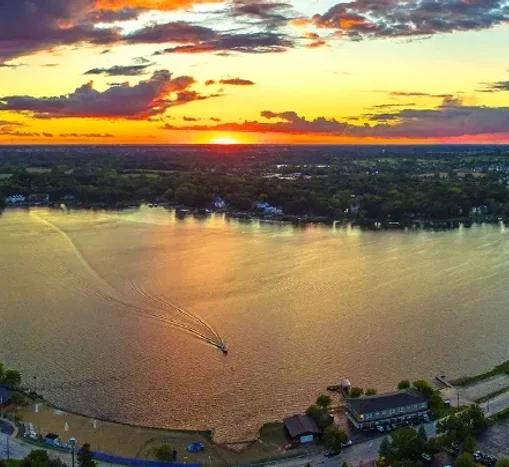 A picture of a lake with a sunset